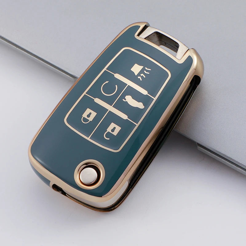 A teal TPU key fob cover with gold accents showing various vehicle keys and a remote control.