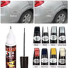 A collection of car paint repair pens in various colors including black, white, silver, and yellow.