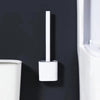 A white wall-mounted toilet brush set with a silicone head is mounted on a dark gray wall.