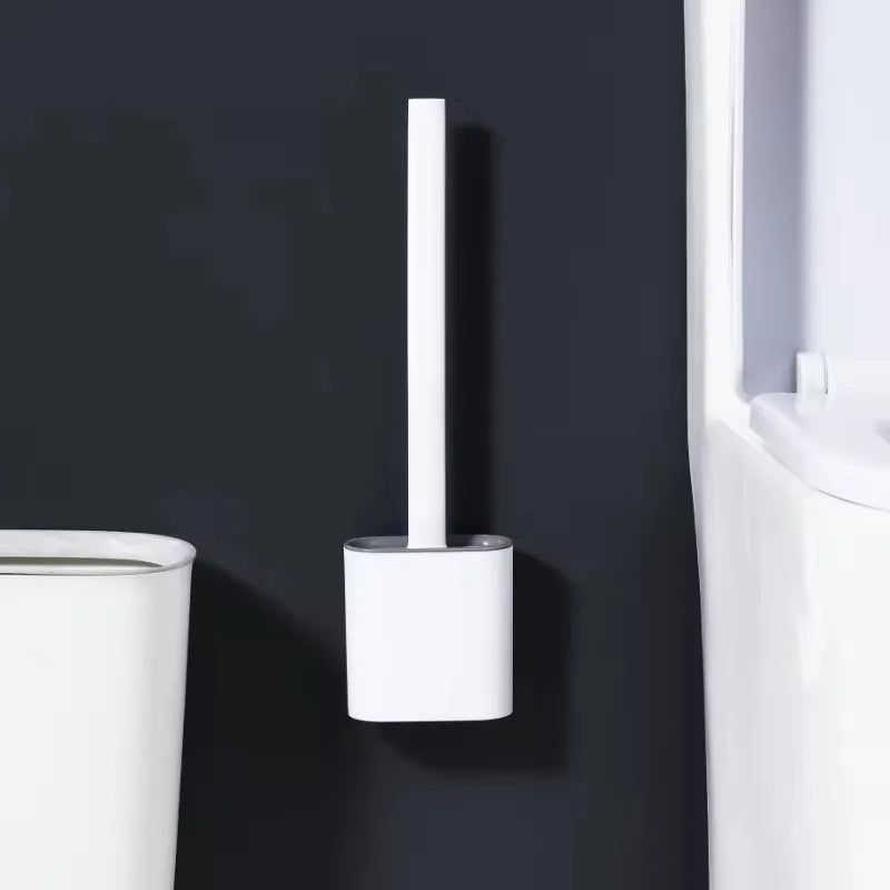A white wall-mounted toilet brush set with a silicone head is mounted on a dark gray wall.