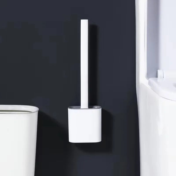 A white wall-mounted toilet brush set with a silicone head is mounted on a dark gray wall.