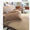 A beige duvet cover set featuring a tan duvet and pillows on a bed with natural light.
