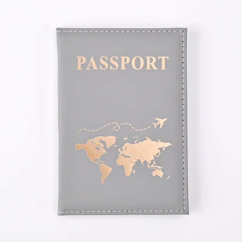 Graues Leder-Passbehörde-Cover mit Goldfolgedruck einer Weltkarte und dem Wort PASSPORT