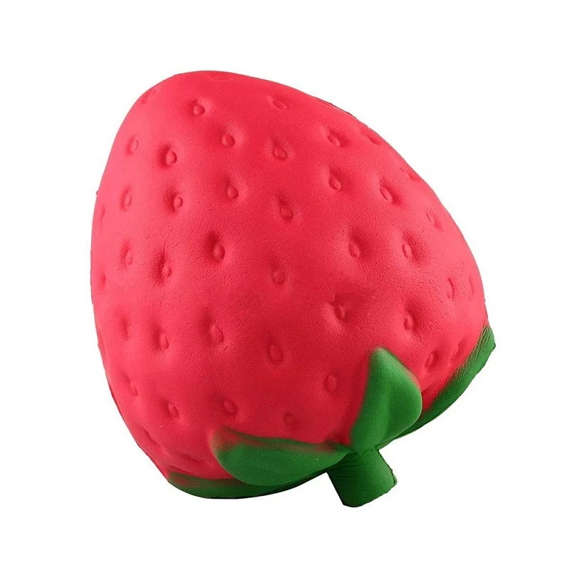 Leuchtend rote Erdbeere-Squishy Stressabbau-Spielzeug mit grünen Blättern.