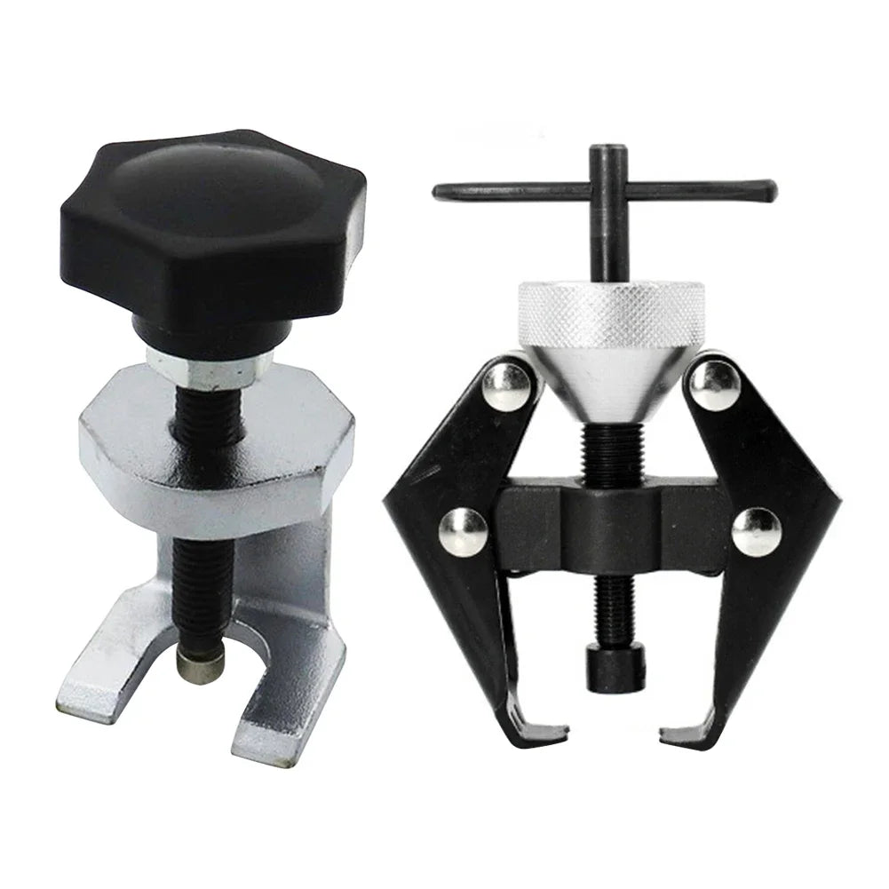 A pair of black and silver two-arm puller tools used for alternator and bearing removal.