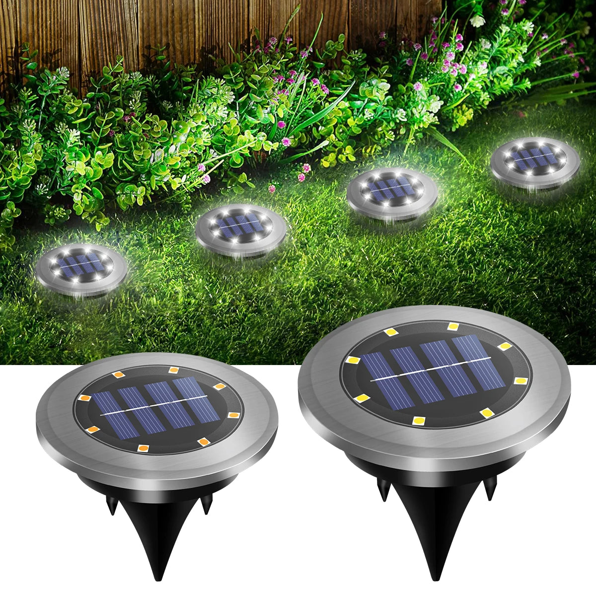 Deux lumières de chemin encastrées solaires LED argentées contre de l'herbe et de la végétation verte.