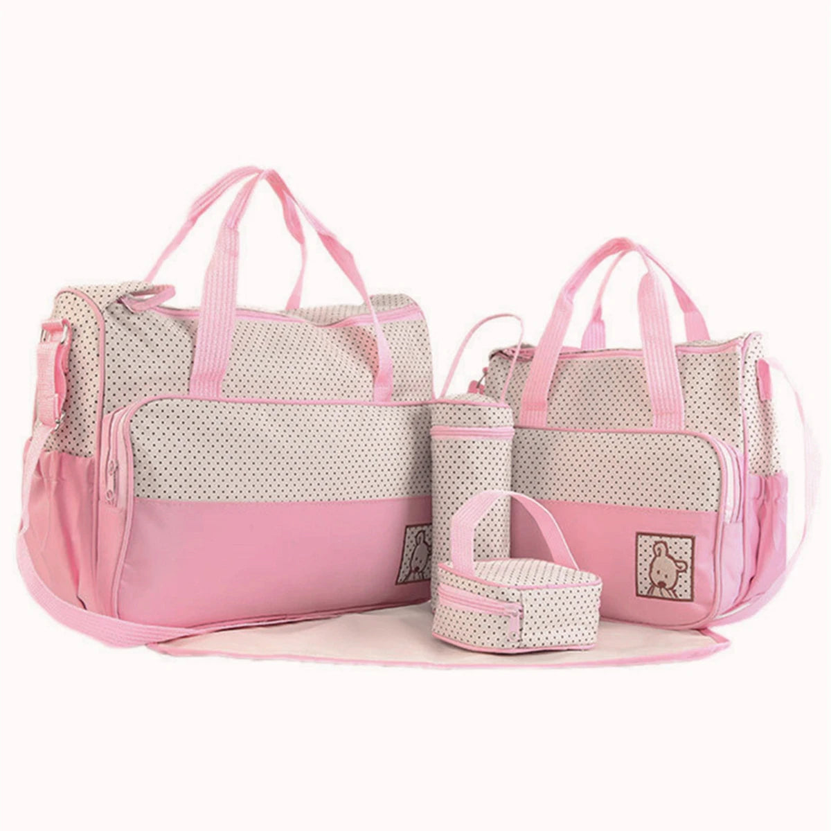 A pink and white multifunctional crossbody diaper bag set with mesh pockets and straps.
