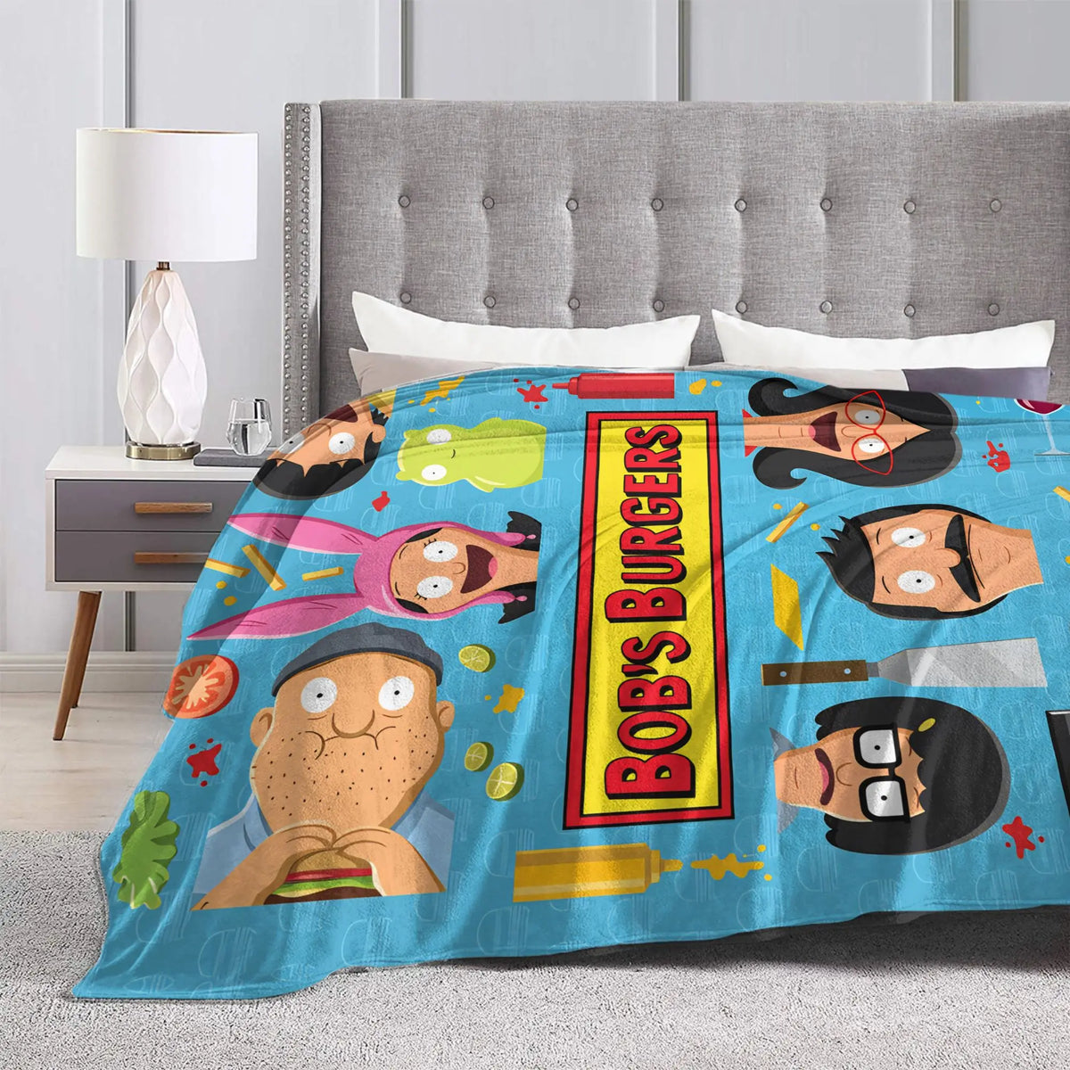 A colorful throw blanket featuring cartoon characters like Bob's Burgers, suitable for home decor.