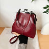 A deep burgundy vintage brown PU leather crossbody handbag is shown resting on a white surface.