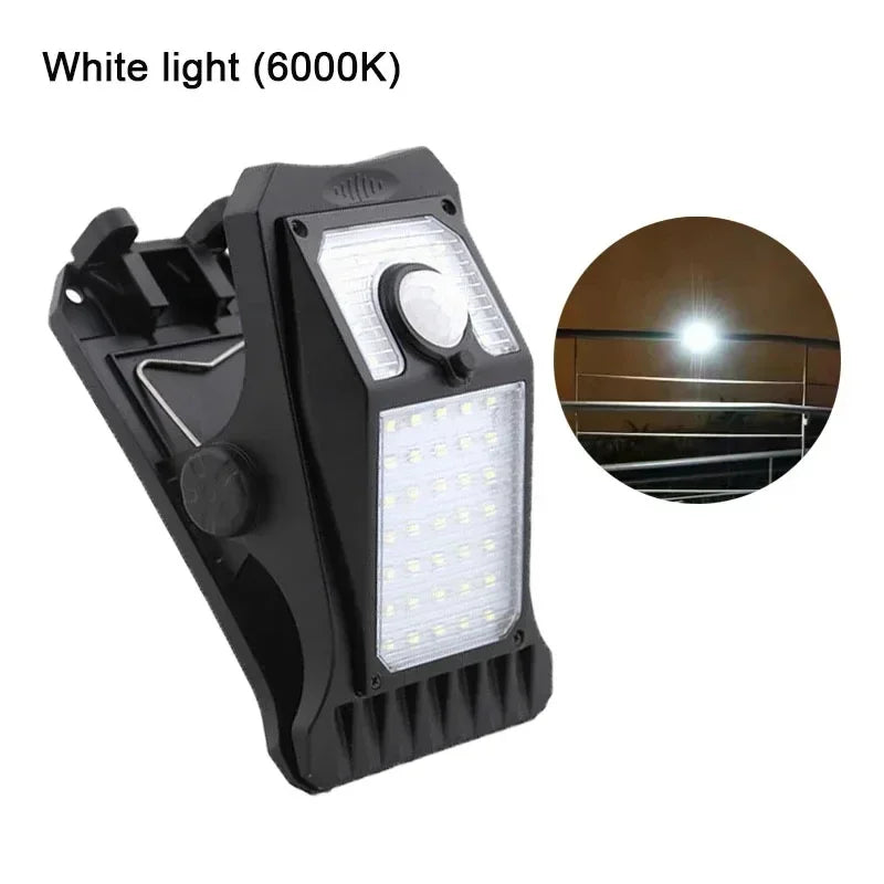 A black solar clip-on outdoor light fixture with a white LED light and motion sensor.
