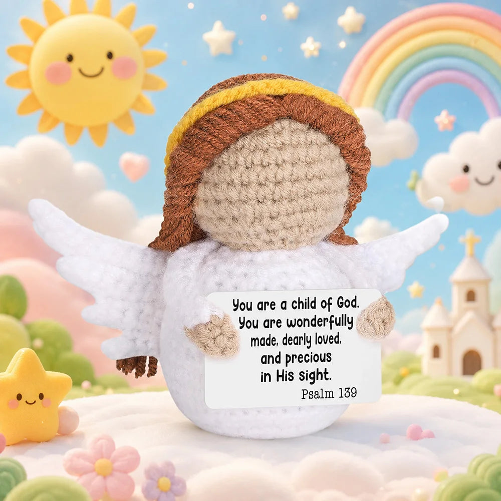 A handmade crochet pocket hug doll with wings and a smiling face is shown against a soft, cloudy background.