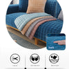 A deep blue velvet sofa cushion cover with a peach accent pillow and various colored fabric options shown on a wooden surface