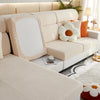 A light beige elegant sofa slipcover featuring tufted upholstery and decorative pillows.