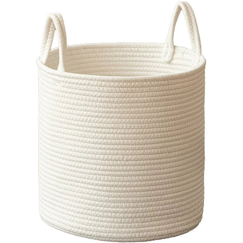 A light beige handwoven cotton rope storage basket with handles.