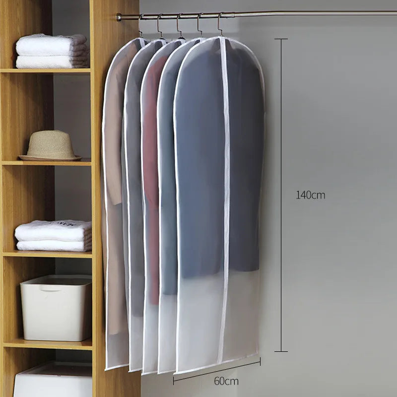 A display of transparent zippered garment bags hanging on a rod, showing various shades of pink and gray.