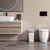 A bathroom vanity featuring a white vessel sink and wooden cabinet, with a modern toilet and a potted plant visible.