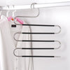 A silver S-shaped pants hanger with multiple black bars is displayed on a white closet rod.