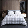 A luxurious white goose down duvet with a cotton cover displayed on a bed in a modern bedroom.