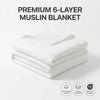 A stack of white premium 6-layer muslin blankets with an OEKO-TEX certified label.