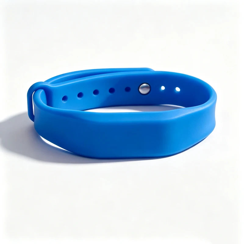 A bright blue silicone wristband with a silver stud, designed for access control.