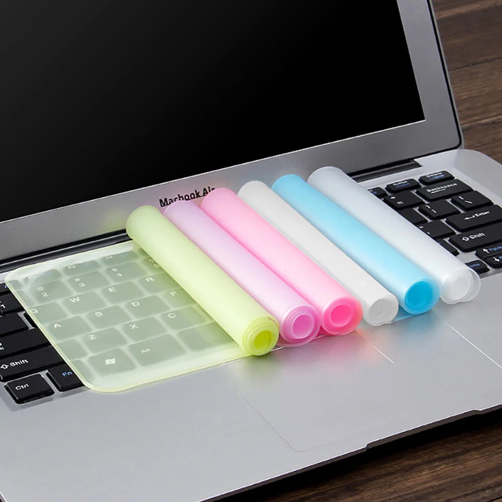 A silicone keyboard cover with multiple colored silicone skins is placed on a laptop keyboard.
