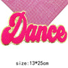 Pink glitter felt letter patch spelling the word Dance with a pink grid background