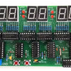 A green electronic circuit board featuring multiple 8-digit LED displays and various components for a digital clock DIY kit.
