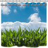 A set of twelve rust-proof metal dragonfly shower curtain hooks hanging against a bright blue sky and clouds above lush green