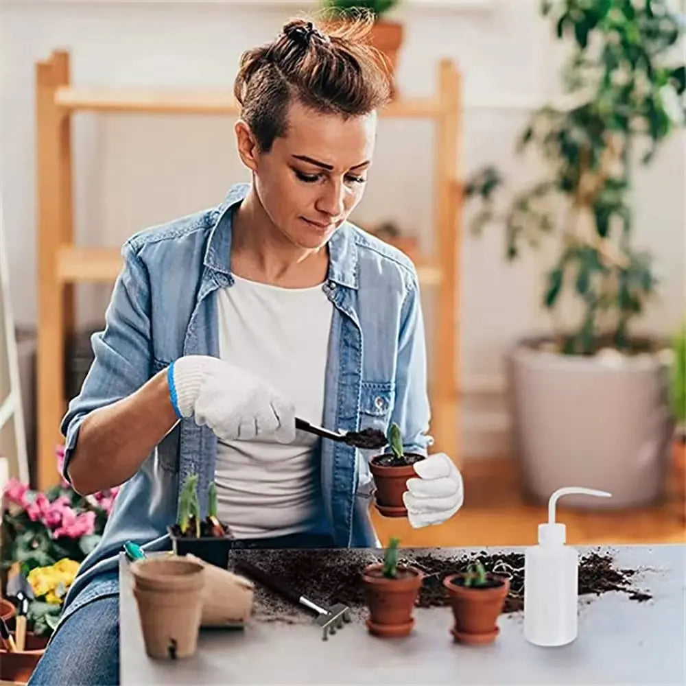 A woman is using a gardening tool kit to care for small potted succulents and bonsai plants.