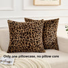 A close-up of a brown leopard print pillowcase resting on a light-colored sofa.