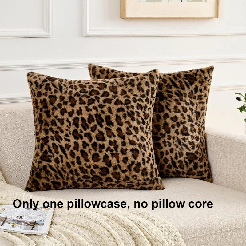 A close-up of a brown leopard print pillowcase resting on a light-colored sofa.