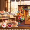 A wooden replica of a vintage Japanese corner shop display with glass windows and colorful items.