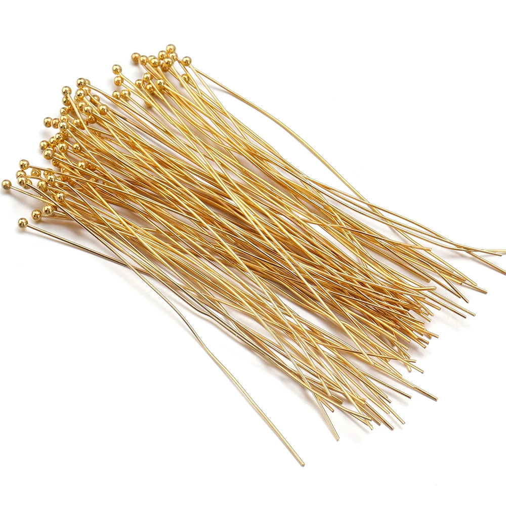 A bundle of gold-plated brass ball head pins for jewelry making.