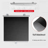 A black cordless retractable roller shade with a silver rod and suction cup hardware, showing a full blackout fabric.
