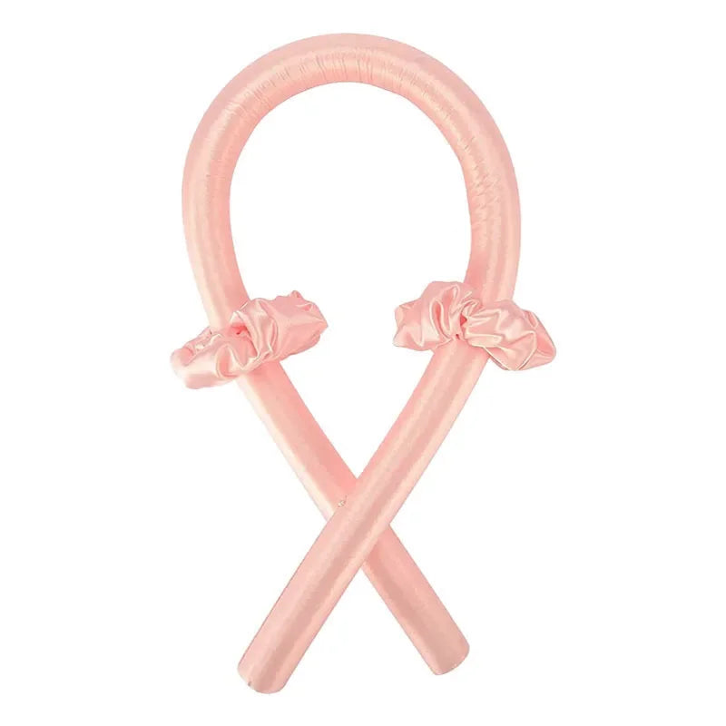 Diadema de seda sin calor rosa con forma de 'X' y detalle de lazo.