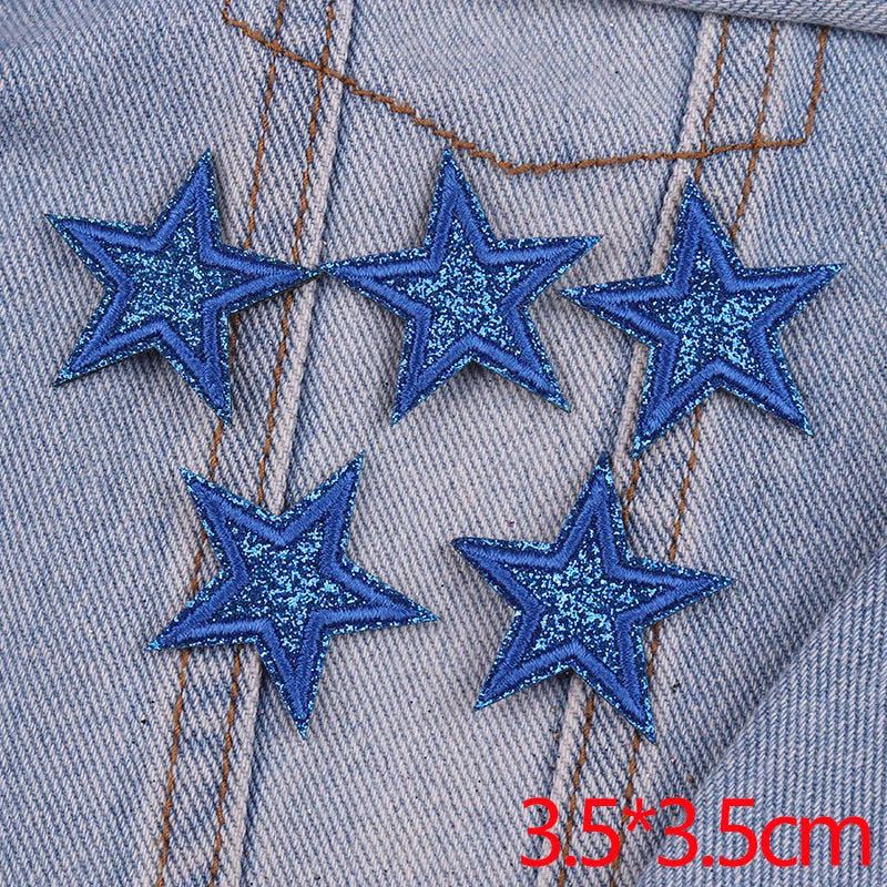Set of five blue glitter star iron-on embroidered patches on denim fabric
