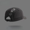 A black Dyx base camp baseball cap with a mesh front and a curved brim is shown against a gray background.