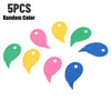 Five random colored plastic box cutters and letter openers scattered on a white background.