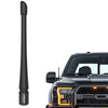 Black universal car radio antenna installed on a black truck.