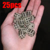 A hand holds a set of 25 glow-in-the-dark acrylic dice for night games.