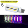 A clear USB LED light featuring a warm filament glow, shown alongside multiple colored glowing bulbs.