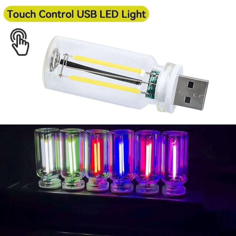 A clear USB LED light featuring a warm filament glow, shown alongside multiple colored glowing bulbs.