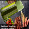 A hand is dispensing olive oil from a dark green glass bottle, which helps slow down oil oxidation.