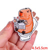 An orange cartoon bear with black markings is embroidered on a white patch, holding a newspaper.