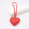 Red heart-shaped PU leather keychain with a cotton peach charm