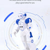 A white and blue interactive dancing robot toy is shown performing a dance motion against a light background.