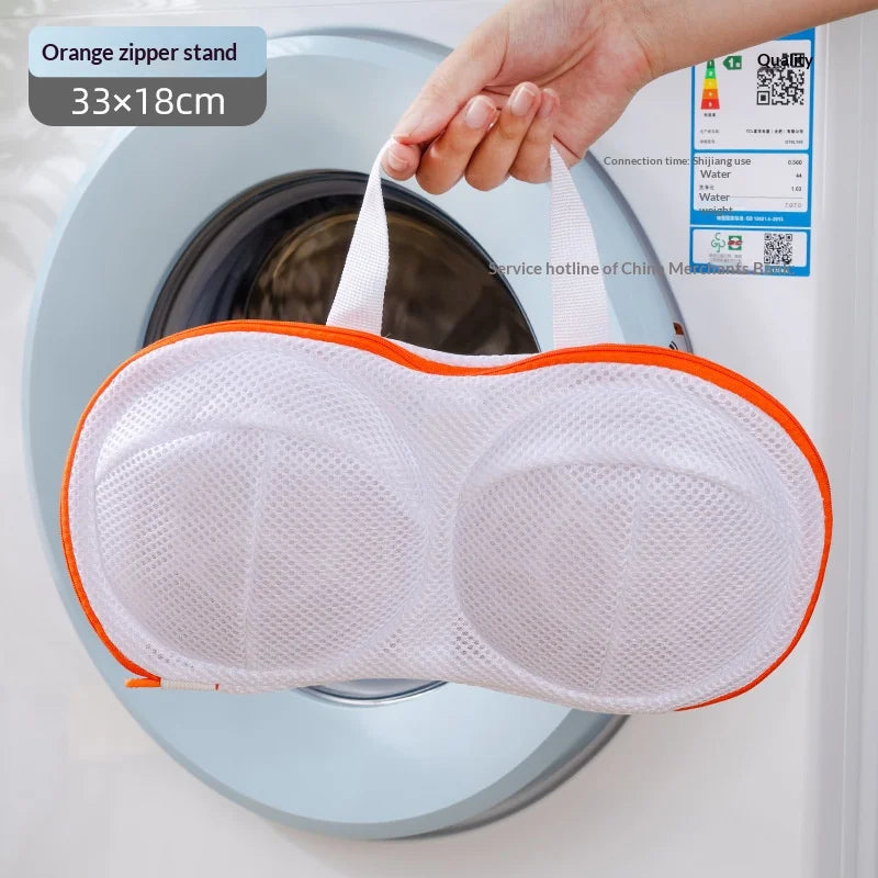 Orange zipper stand mesh laundry bag for delicates placed inside a washing machine drum