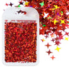 A white plastic container filled with red and orange holographic star sequins.
