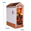 A miniature DIY book nook kit depicting a detailed room scene with wooden accents and interior display.