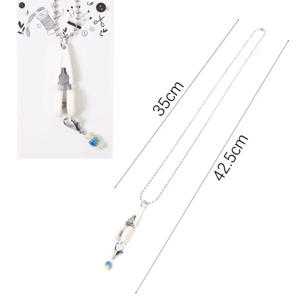Silver precision mini scissors with a protective cover displayed against a white background.